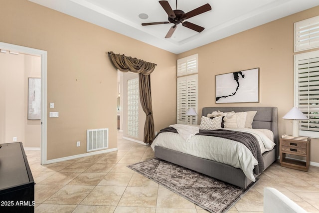 28247 N 128th Dr, Peoria, AZ 85383 - bedroom with ceiling fan, baseboards, visible vents, and a raised ceiling