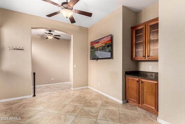 28247 N 128th Dr, Peoria, AZ 85383 - interior space with a ceiling fan, arched walkways, and baseboards
