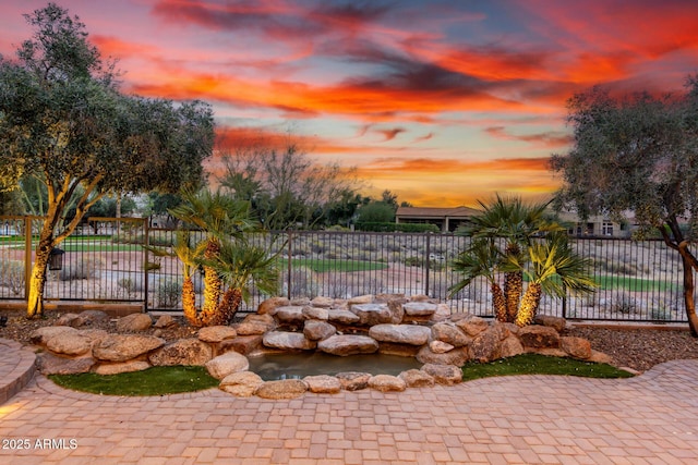 28247 N 128th Dr, Peoria, AZ 85383 - yard at dusk featuring fence and a garden pond