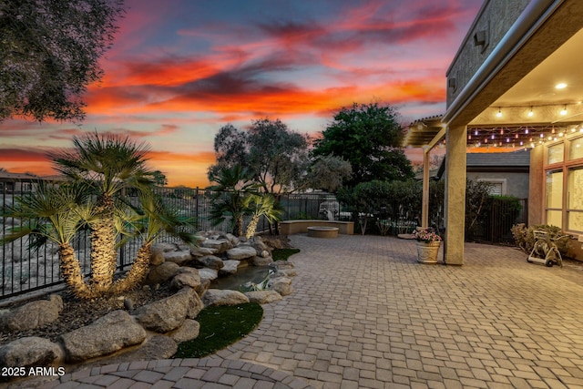 28247 N 128th Dr, Peoria, AZ 85383 - patio terrace at dusk featuring a fenced backyard