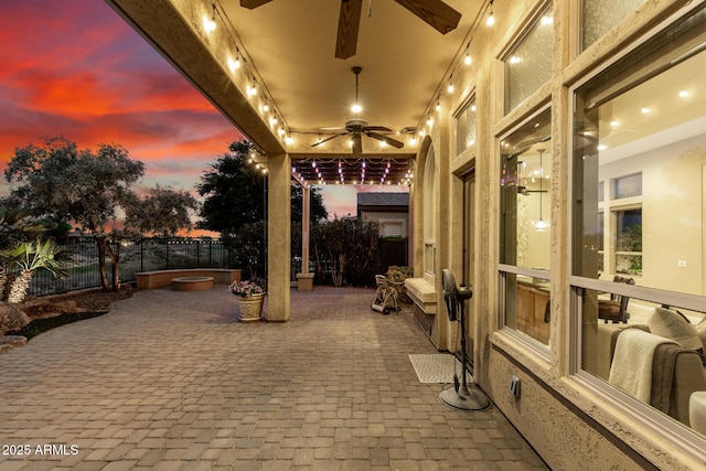 28247 N 128th Dr, Peoria, AZ 85383 - patio terrace at dusk with fence and a ceiling fan