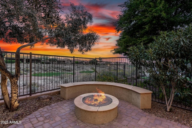 28247 N 128th Dr, Peoria, AZ 85383 - patio terrace at dusk featuring an outdoor fire pit and fence