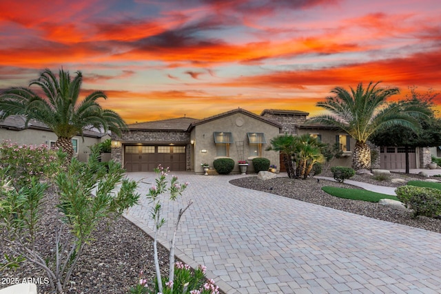 28247 N 128th Dr, Peoria, AZ 85383 - mediterranean / spanish home with a garage, decorative driveway, and stucco siding