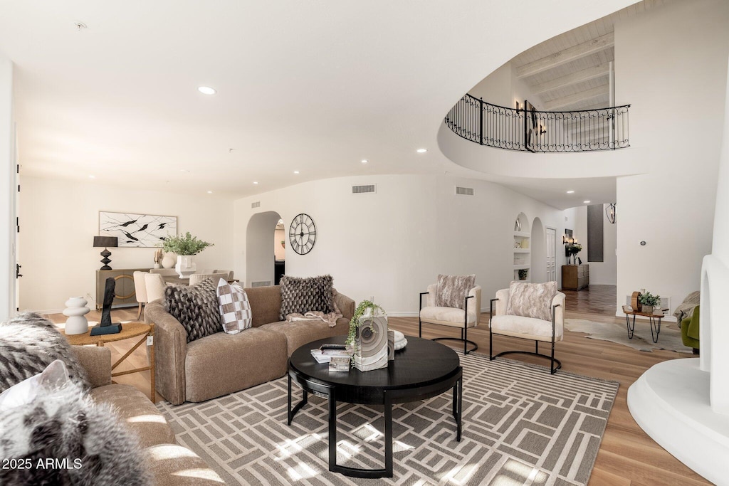 living room with lofted ceiling and hardwood / wood-style flooring