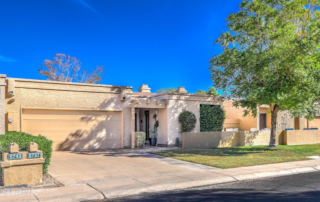 view of front of house with a front lawn and a garage