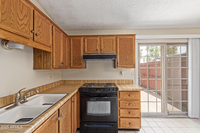 6711 W Osborn Rd Unit 82, Phoenix, AZ 85033 - kitchen featuring black electric range oven, under cabinet range hood, light tile patterned floors, a textured ceiling, and light countertops