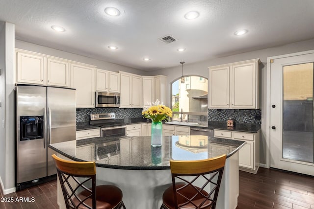 5628 N Rattler Way, Litchfield Park, AZ 85340 - kitchen with appliances with stainless steel finishes, dark wood finished floors, decorative backsplash, and recessed lighting
