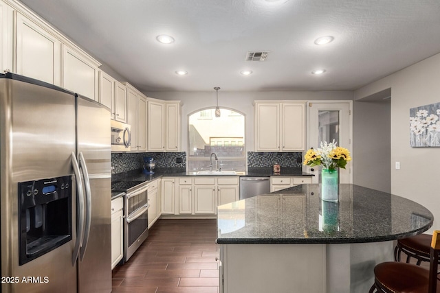 5628 N Rattler Way, Litchfield Park, AZ 85340 - kitchen with stainless steel appliances, a sink, decorative backsplash, dark wood-style floors, and recessed lighting