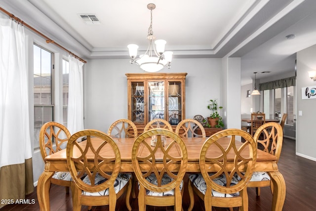 5628 N Rattler Way, Litchfield Park, AZ 85340 - dining space with a chandelier, dark wood finished floors, a tray ceiling, and baseboards
