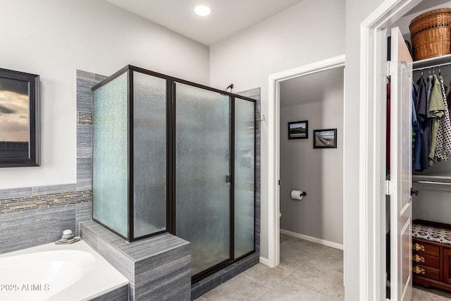 5628 N Rattler Way, Litchfield Park, AZ 85340 - full bathroom featuring a spacious closet, a stall shower, a bath, and tile patterned floors