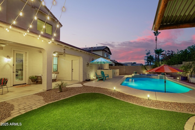 5628 N Rattler Way, Litchfield Park, AZ 85340 - pool at dusk featuring a fenced backyard and a patio area