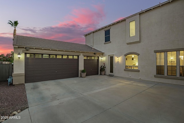 5628 N Rattler Way, Litchfield Park, AZ 85340 - view of front of home featuring concrete driveway, stucco siding, an attached garage, and a tiled roof