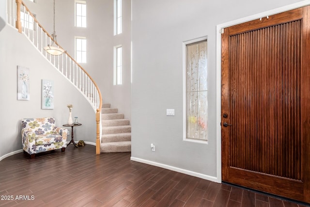 5628 N Rattler Way, Litchfield Park, AZ 85340 - entrance foyer featuring stairs, baseboards, dark wood-style floors, and a towering ceiling
