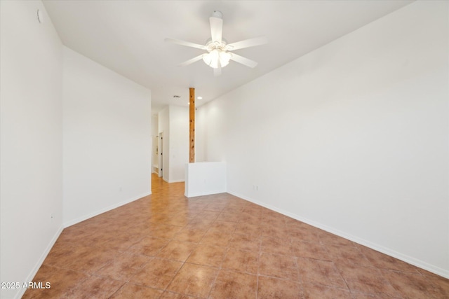 empty room with light tile patterned floors, baseboards, and ceiling fan