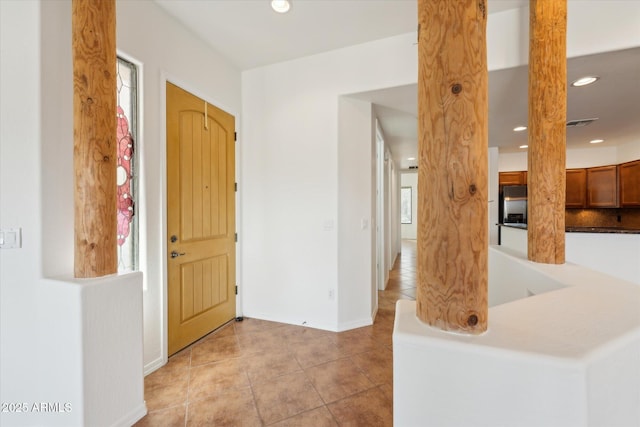 foyer entrance featuring recessed lighting, visible vents, baseboards, and light tile patterned floors