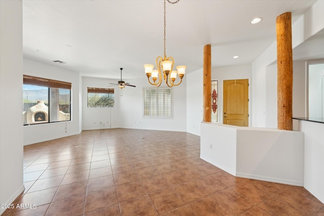 empty room with recessed lighting, baseboards, tile patterned floors, and ceiling fan with notable chandelier