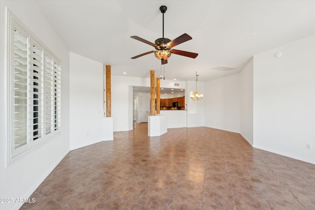 unfurnished living room with ceiling fan with notable chandelier, visible vents, and baseboards