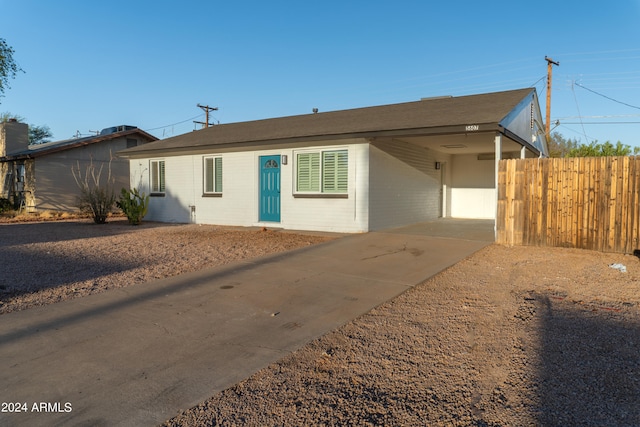 ranch-style house featuring a carport