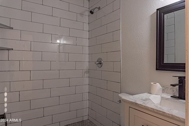 bathroom featuring vanity and tiled shower