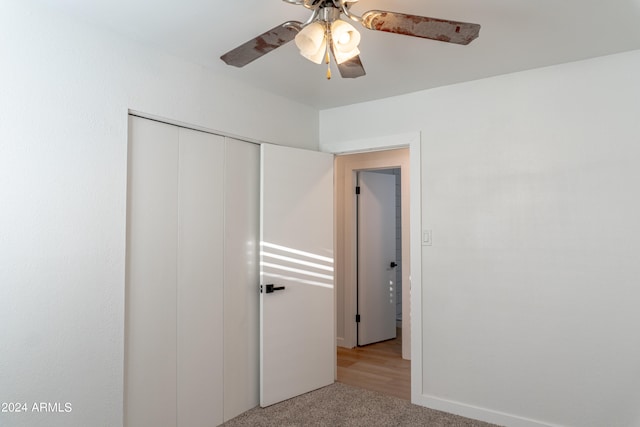 unfurnished bedroom with a closet, ceiling fan, and light wood-type flooring