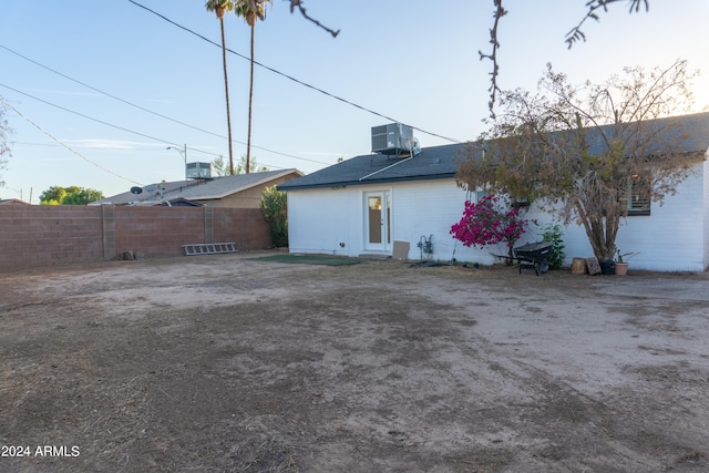 rear view of property with central AC