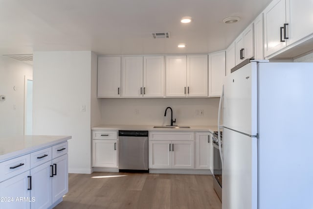 kitchen featuring light hardwood / wood-style floors, white cabinets, stainless steel appliances, and sink