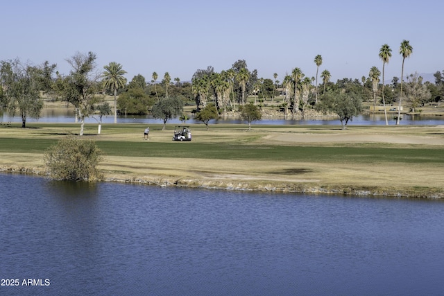 view of property's community with a water view and a yard