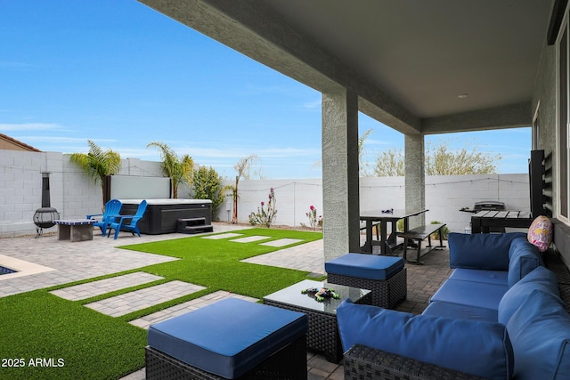 view of patio / terrace with an outdoor living space with a fire pit and a hot tub