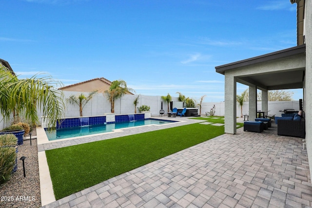 exterior space featuring a lawn, outdoor lounge area, pool water feature, and a patio area