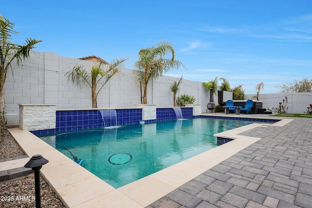 view of swimming pool featuring pool water feature and a patio area