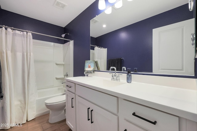 full bathroom with vanity, hardwood / wood-style flooring, toilet, and shower / bath combo with shower curtain