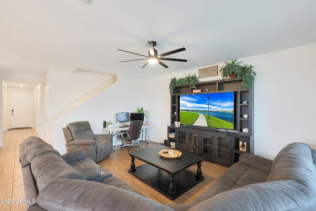 living room featuring hardwood / wood-style flooring and ceiling fan