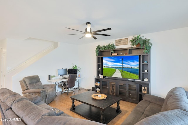 living room featuring ceiling fan and light wood-type flooring