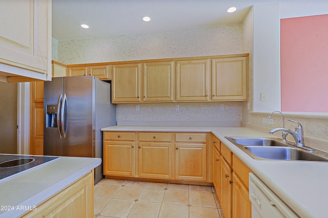 kitchen featuring sink, stainless steel refrigerator with ice dispenser, light tile patterned floors, white dishwasher, and light brown cabinetry