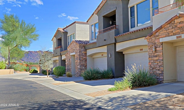 view of front of home featuring a balcony and a garage