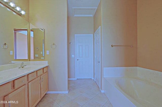 bathroom with tile patterned flooring, vanity, and a washtub