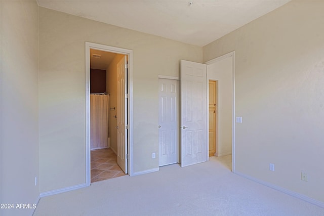 unfurnished bedroom with light carpet