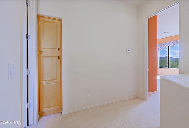 corridor with light colored carpet