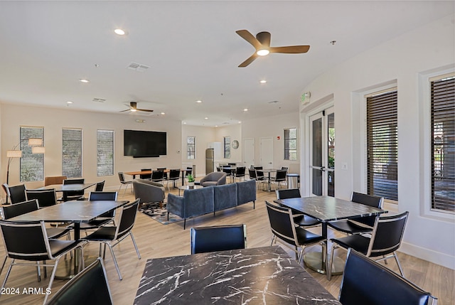 dining room with ceiling fan and light wood-type flooring