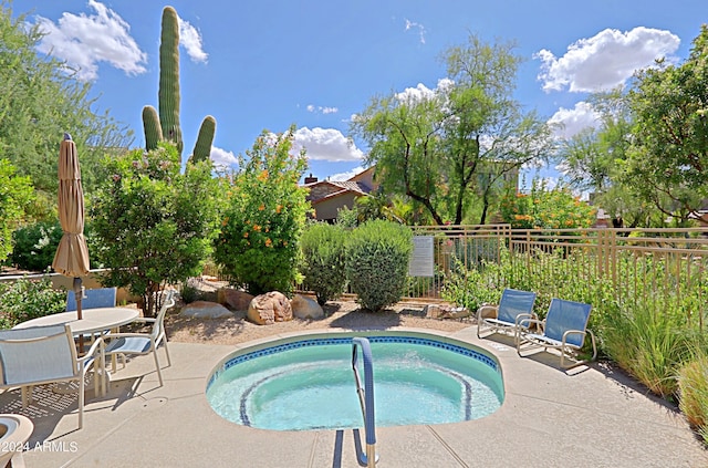 view of pool with a patio and an in ground hot tub