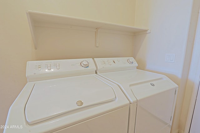 clothes washing area with separate washer and dryer