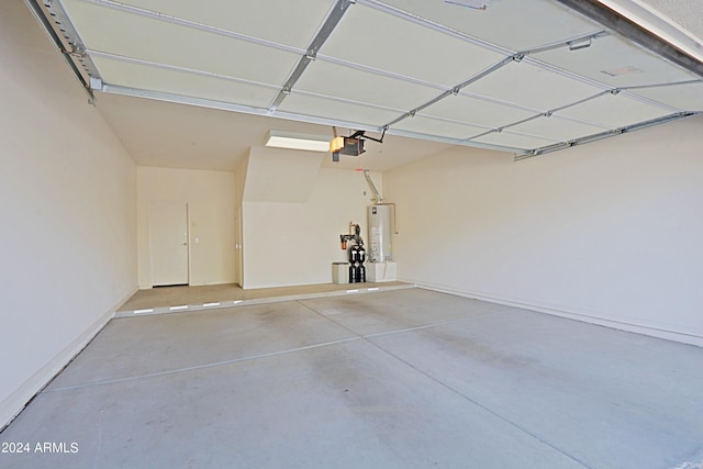 garage with water heater and a garage door opener