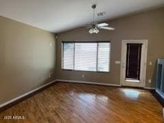 unfurnished living room featuring baseboards, lofted ceiling, and wood finished floors