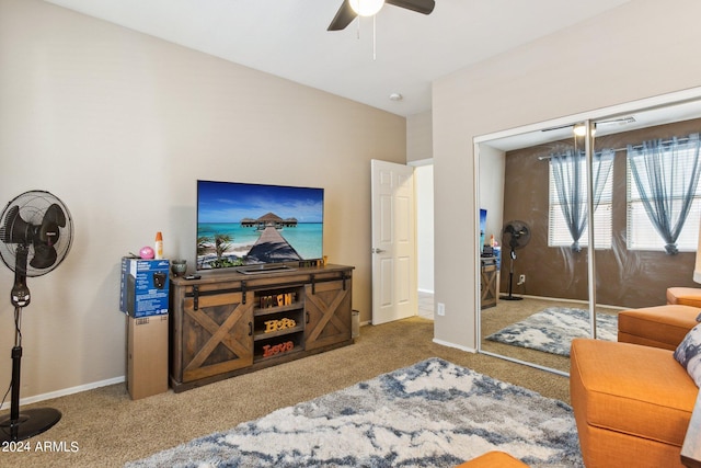 living room with ceiling fan and carpet flooring