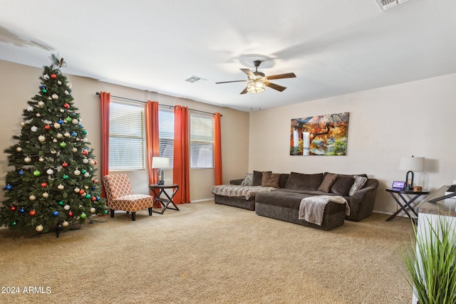 carpeted living room with ceiling fan