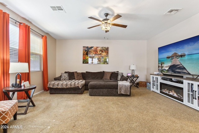 carpeted living room with ceiling fan