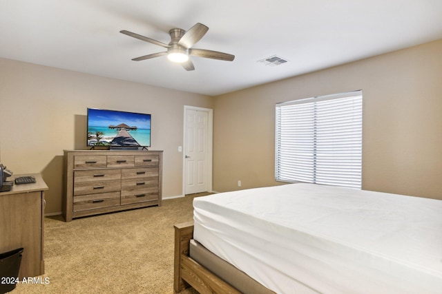 bedroom with light carpet and ceiling fan