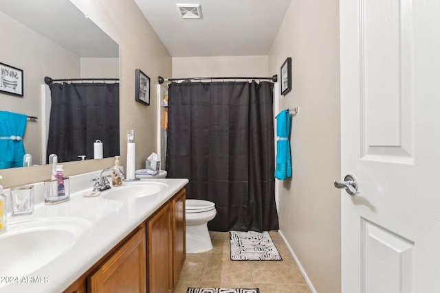 bathroom featuring vanity, toilet, a shower with shower curtain, and tile patterned floors