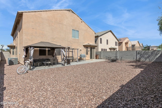 back of property featuring a patio, a gazebo, and central air condition unit