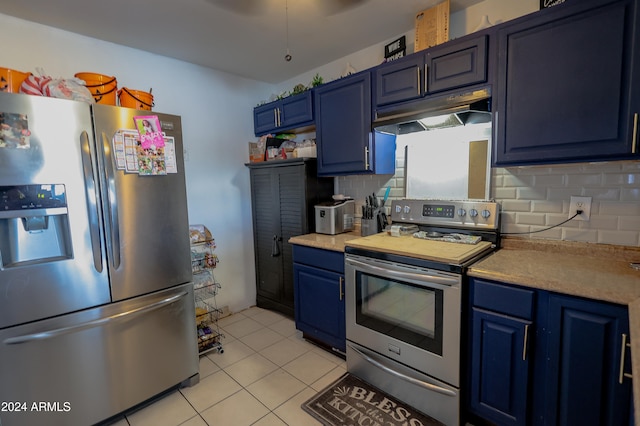 kitchen featuring blue cabinetry, decorative backsplash, stainless steel appliances, and light tile patterned flooring